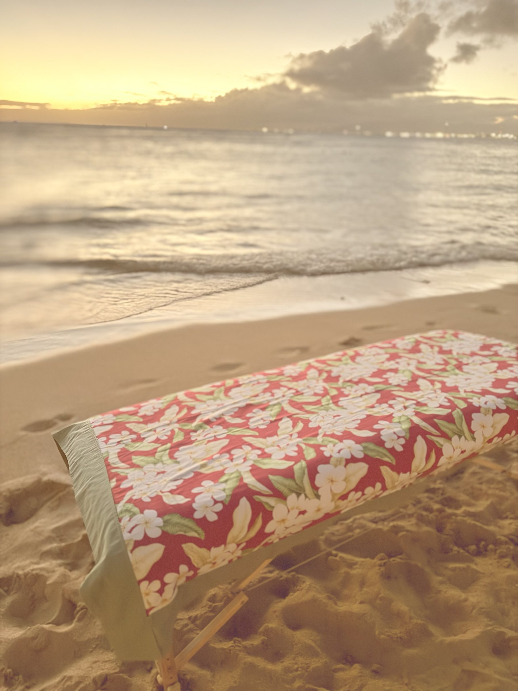 Massage table set up on the beach at sunset