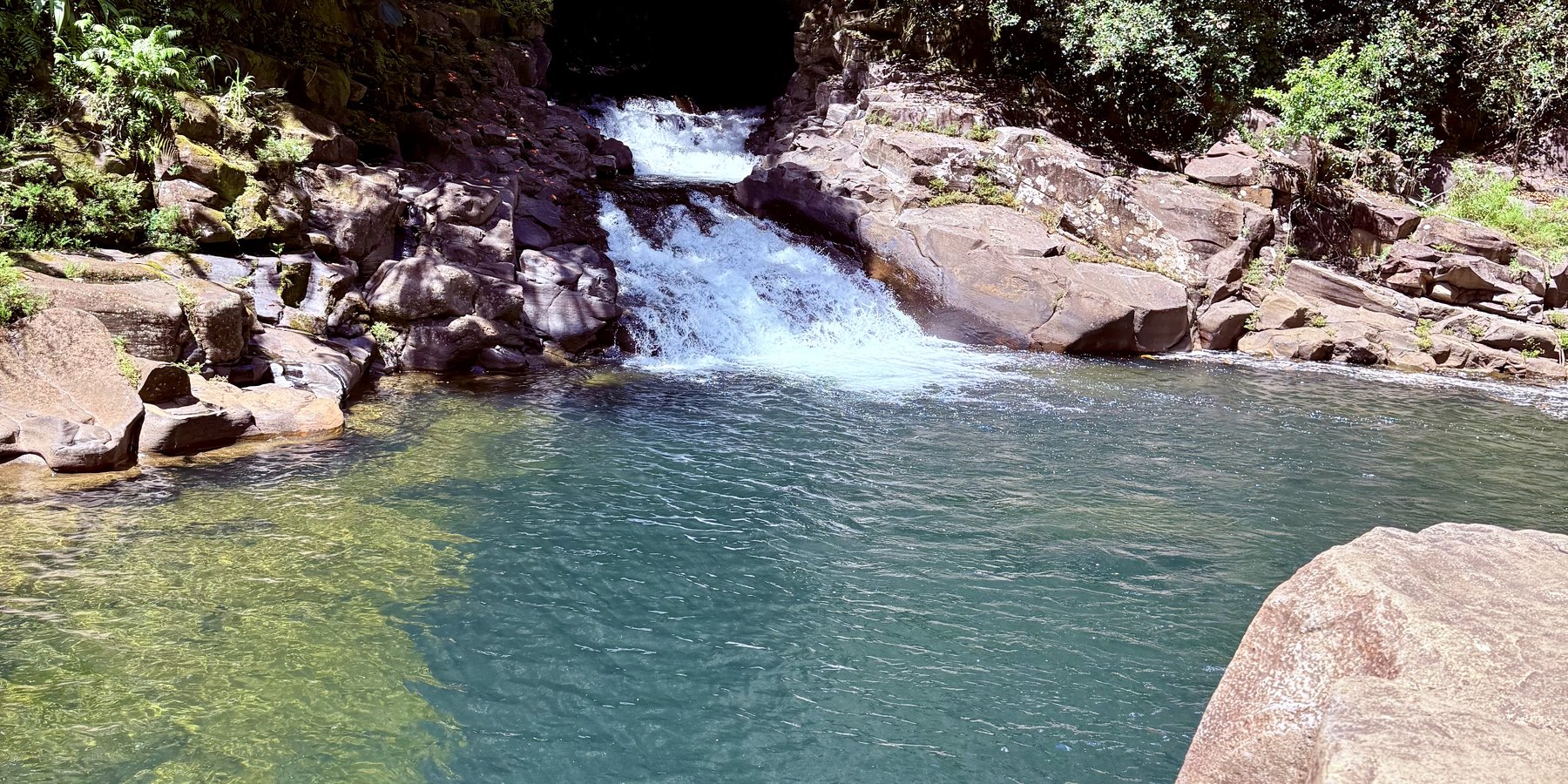 A gentle waterfall flowing into a calm, clear pool